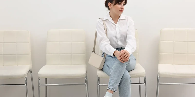woman sitting on white chair