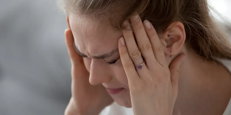woman with hands on head